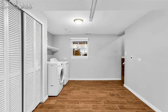 a view of a storage & utility room with two washing machine