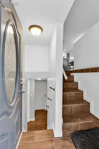 a view of entryway and hall with wooden floor