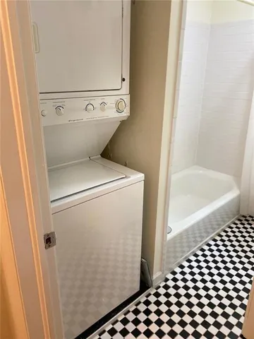 a bathroom with a granite countertop toilet and a shower