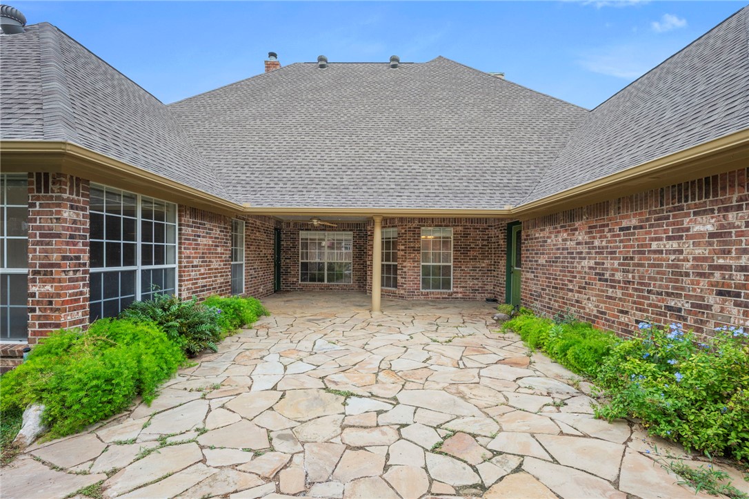 713 Willow Loop College Station, TX 77845 - Photo 31 of 39 a front view of a house with a garden