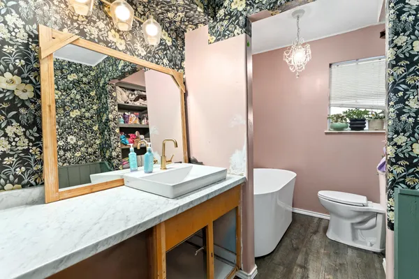 a bathroom with a granite countertop sink and a mirror