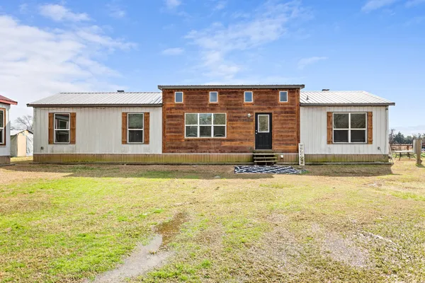 a house view with swimming pool in front of it