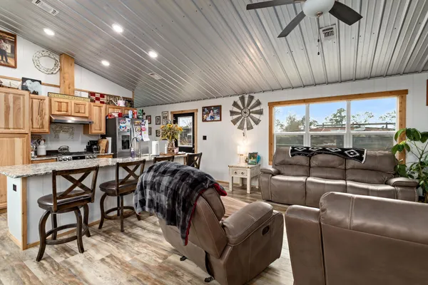 a living room with lots of furniture and a large window