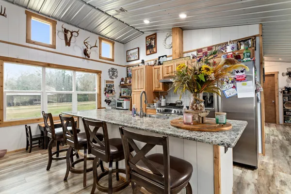 a dining hall with furniture and a floor to ceiling window