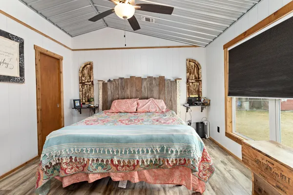 a large bed sitting in a bedroom next to a window