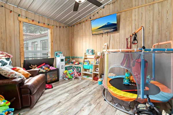 a children room with furniture and a window