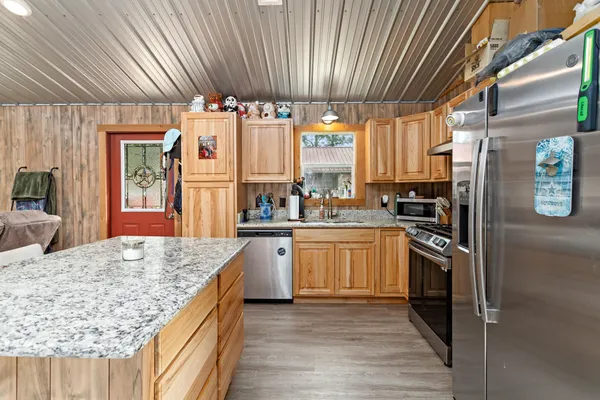 a kitchen with granite countertop a stove and refrigerator
