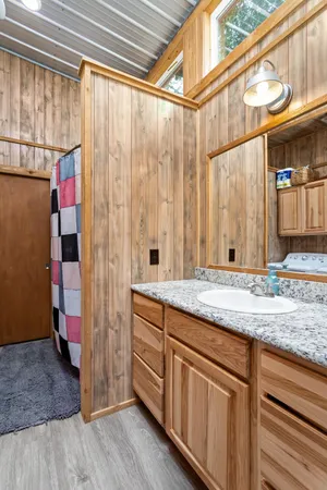 a bathroom with a granite countertop sink and a mirror