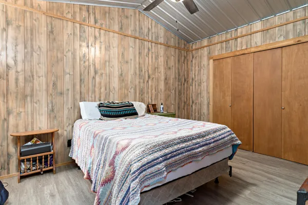 a bedroom with a bed and wooden floor