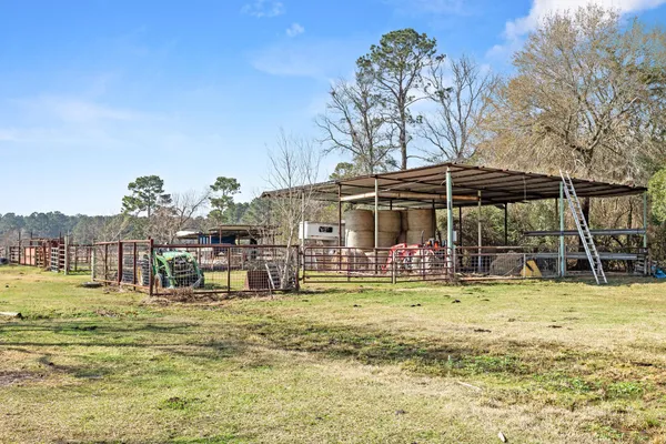 a view of a swimming pool with a lawn chairs under an umbrella