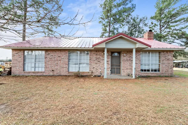 a front view of a house with a garden and garage