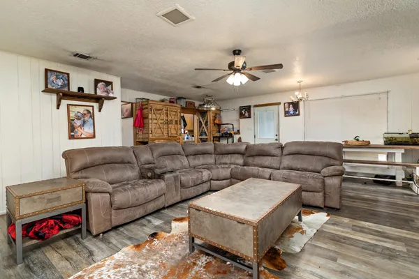 a living room with furniture and kitchen view