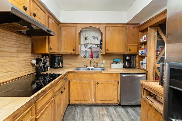 a kitchen with stainless steel appliances granite countertop a sink and cabinets