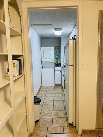 a kitchen with a sink a refrigerator and cabinets