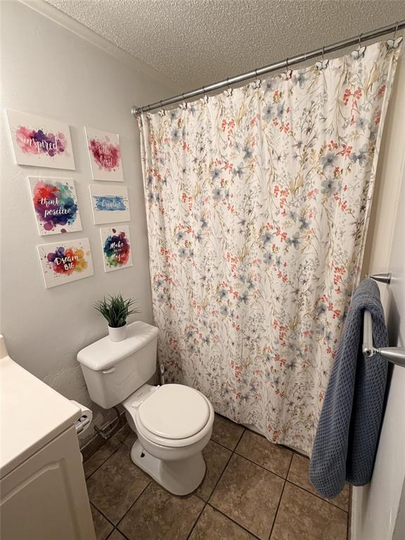 2490 Southwest 14th Drive, Unit 29 Gainesville, FL 32608 - Photo 12 of 20 a white toilet sitting next to a shower curtain