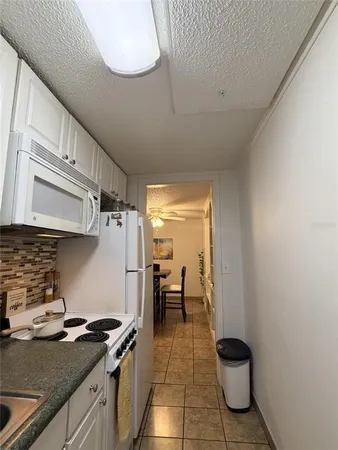 a kitchen with a sink and a stove top oven