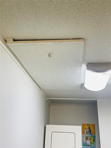 a view of a hallway with wooden floor and a bathroom
