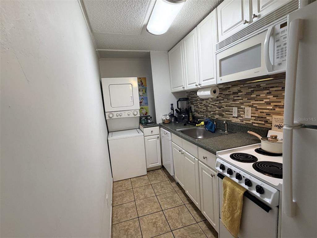 2490 Southwest 14th Drive, Unit 29 Gainesville, FL 32608 - Photo 18 of 20 a kitchen with a stove and a sink