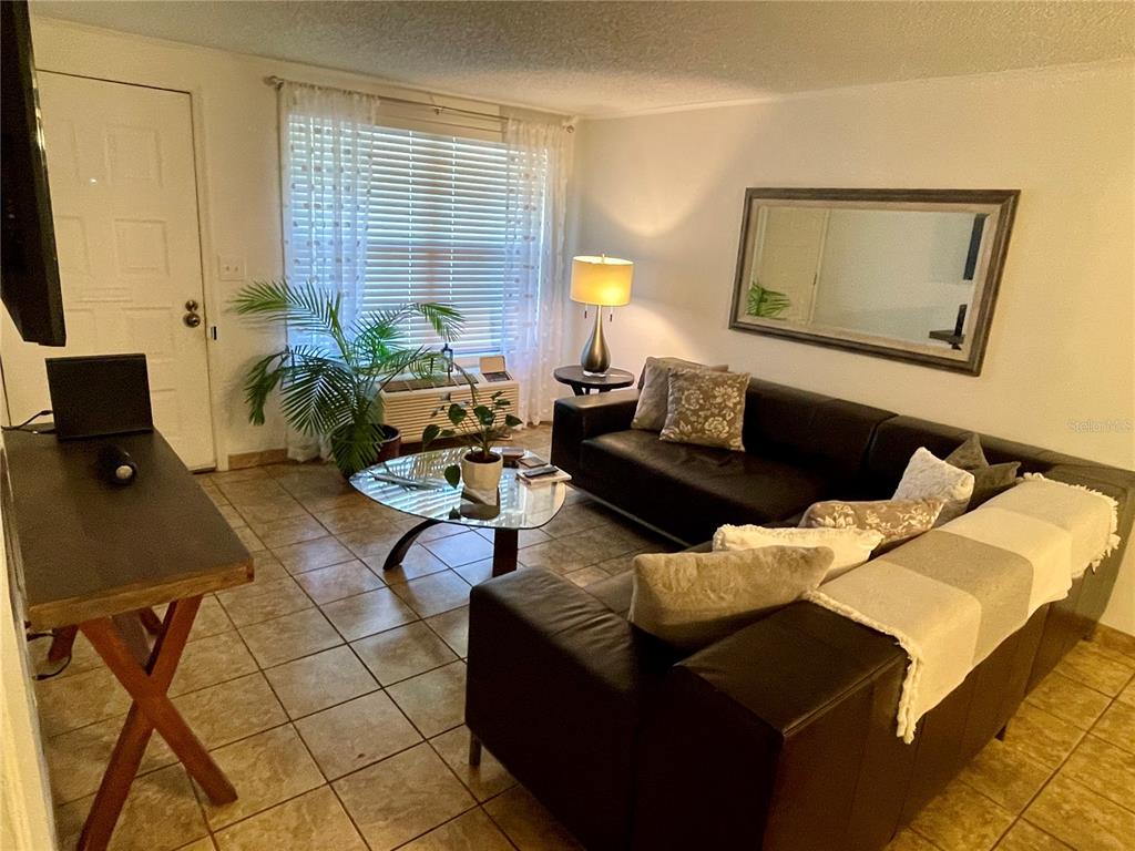 2490 Southwest 14th Drive, Unit 29 Gainesville, FL 32608 - Photo 2 of 20 a living room with furniture and a window