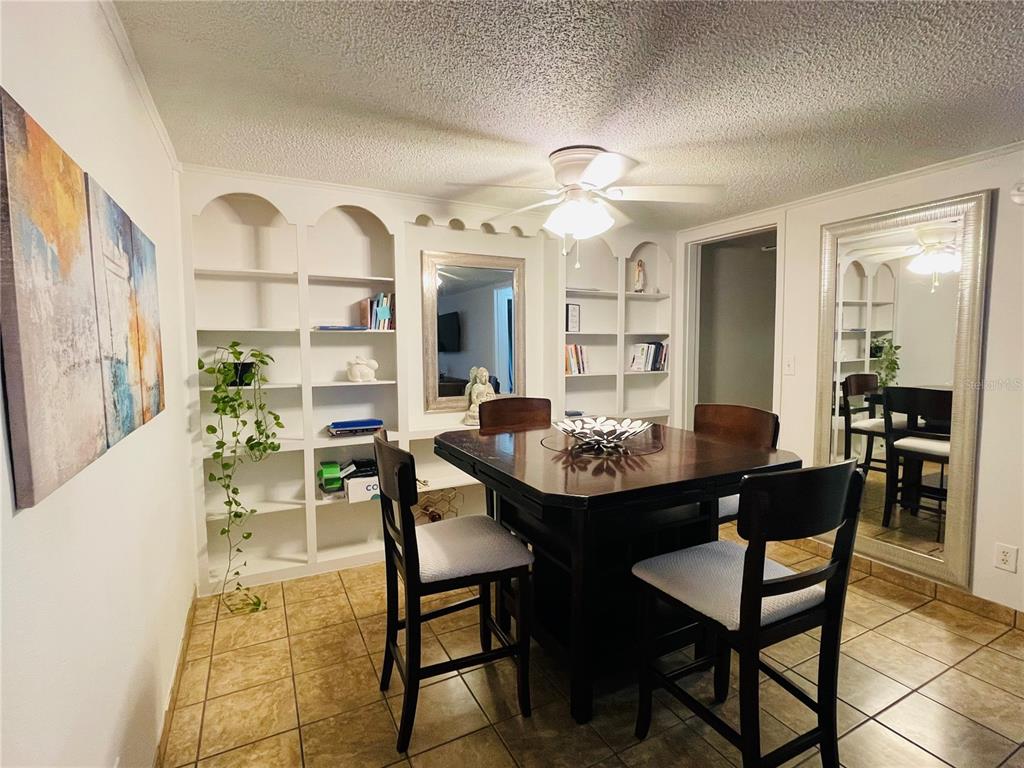 2490 Southwest 14th Drive, Unit 29 Gainesville, FL 32608 - Photo 3 of 20 a view of a dining room with furniture