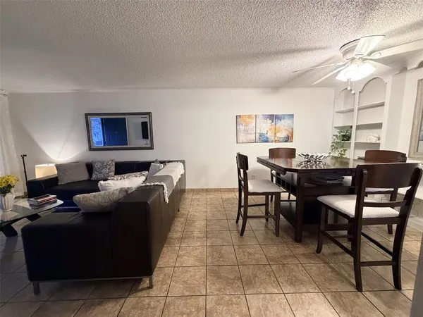 a living room with furniture a window and a table