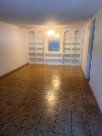 a view of an empty room and empty shelves