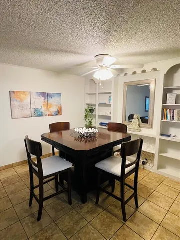 a view of a dining room and livingroom with furniture a rug and a painting