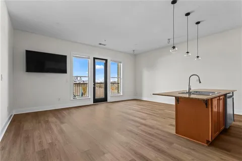 a kitchen with stainless steel appliances granite countertop a refrigerator a stove a sink and a microwave