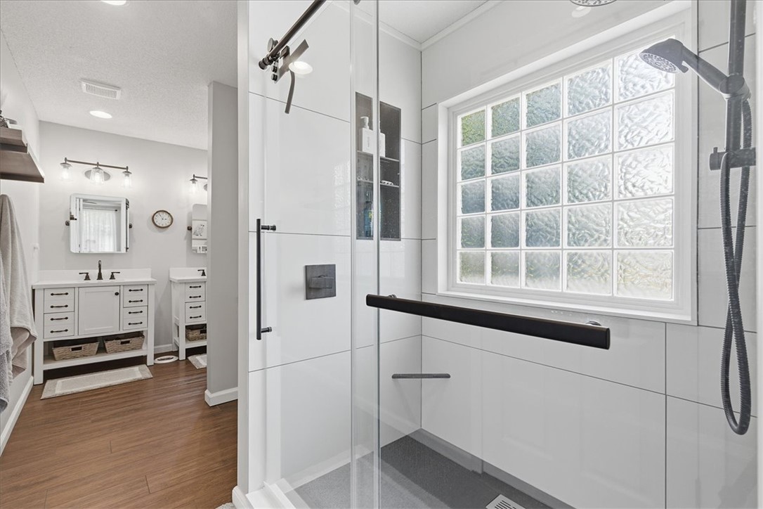 166 Amberwood Drive Anderson, SC 29621 - Photo 15 of 38 This primary bathroom boasts a spacious glass-enclosed shower and a dual vanity with ample storage.