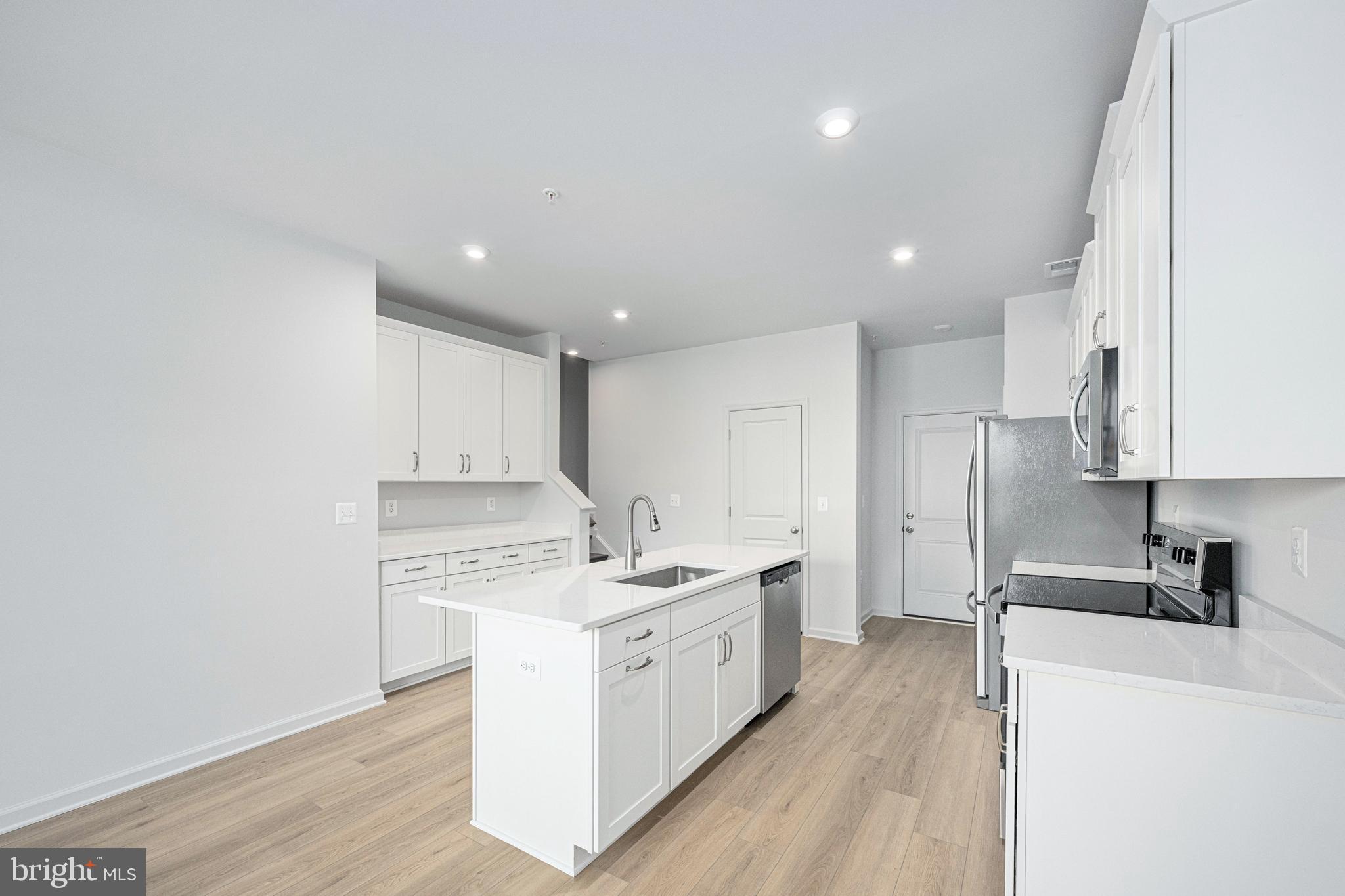 2540 Neabsco Common Place Woodbridge, VA 22191 - Photo 13 of 33 a kitchen with a sink a counter top space and cabinets