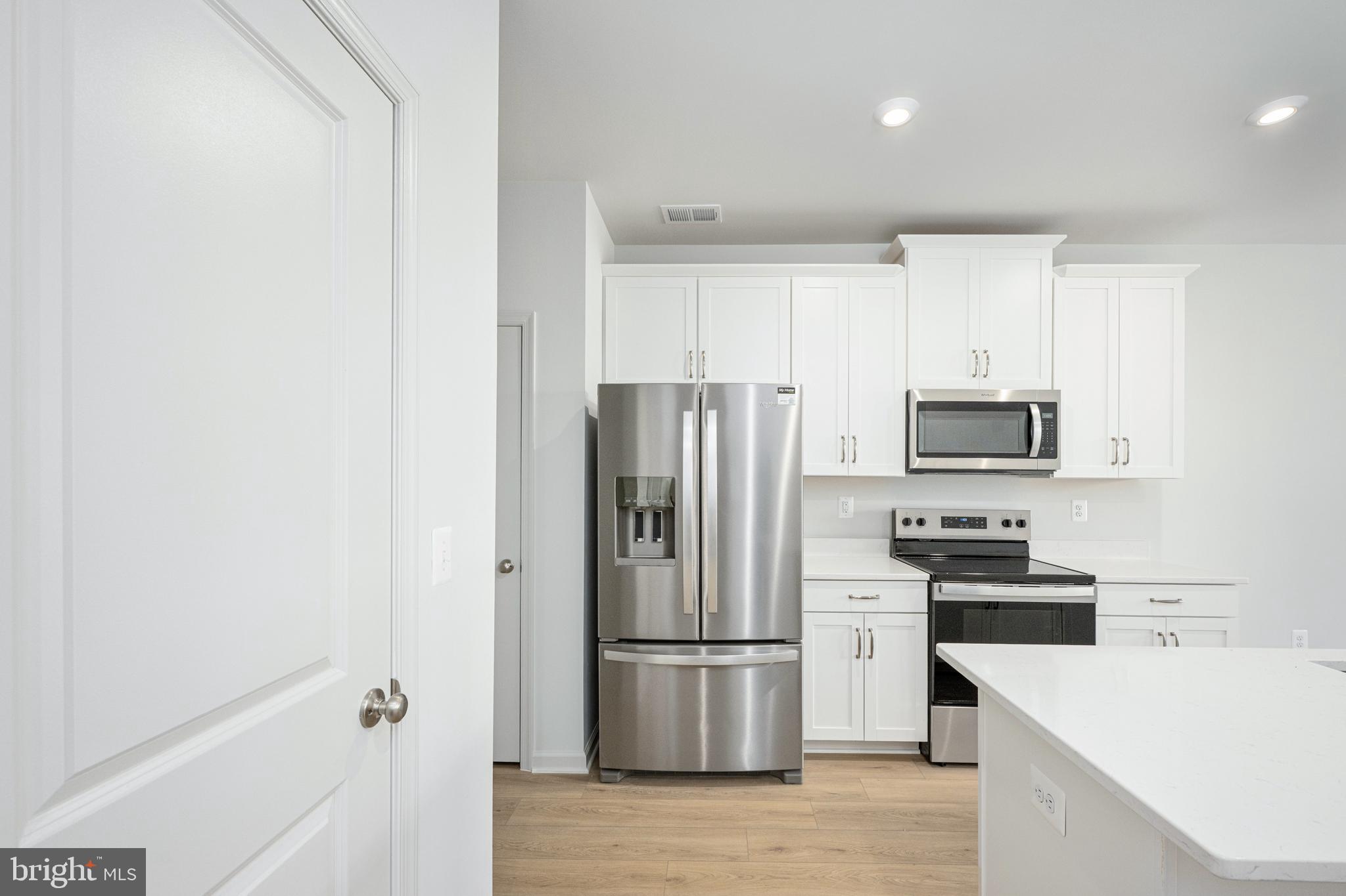 2540 Neabsco Common Place Woodbridge, VA 22191 - Photo 14 of 33 a kitchen with a refrigerator a stove a microwave and cabinets