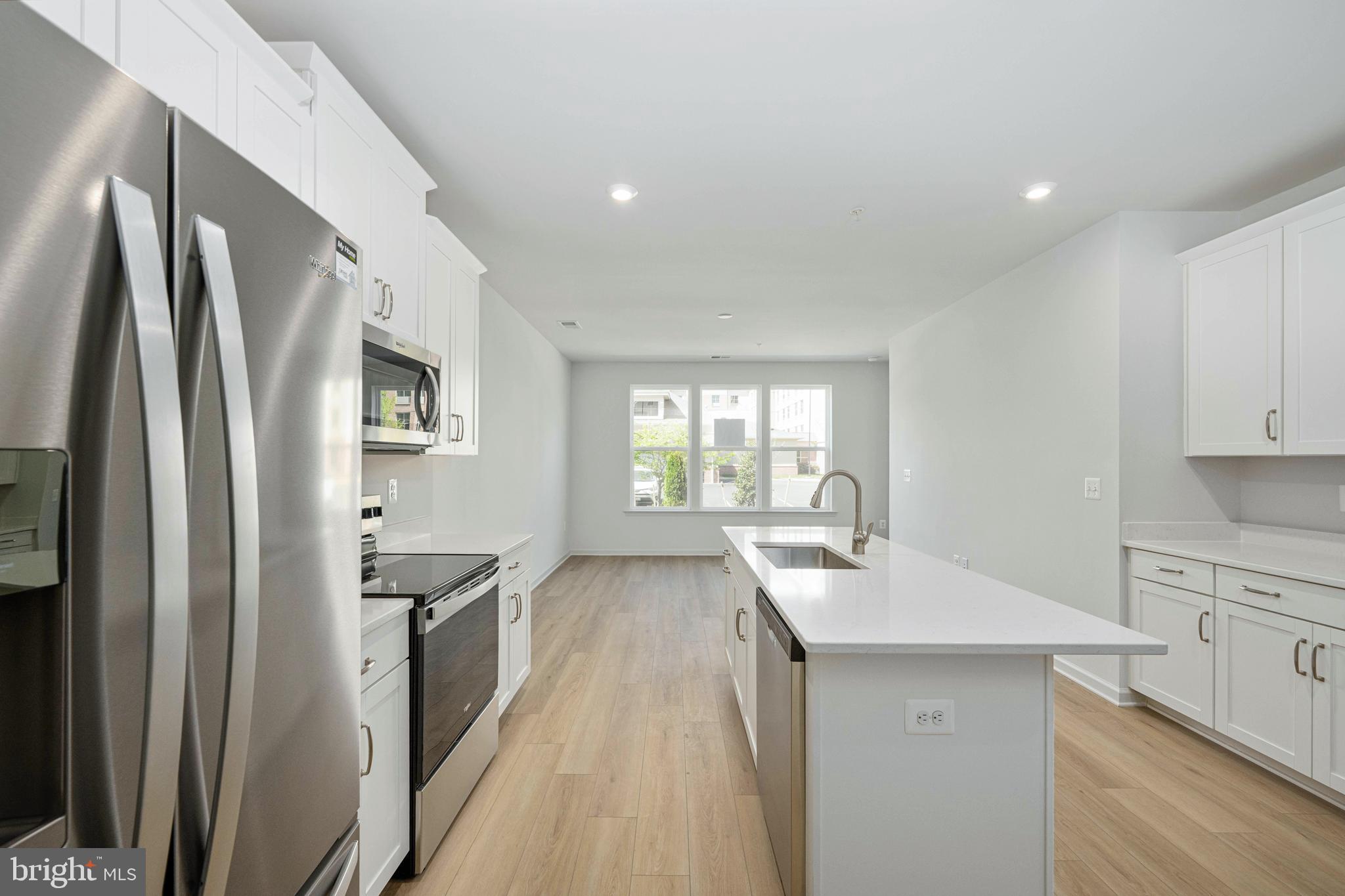 2540 Neabsco Common Place Woodbridge, VA 22191 - Photo 15 of 33 a kitchen with stainless steel appliances hardwood floor sink stove and refrigerator
