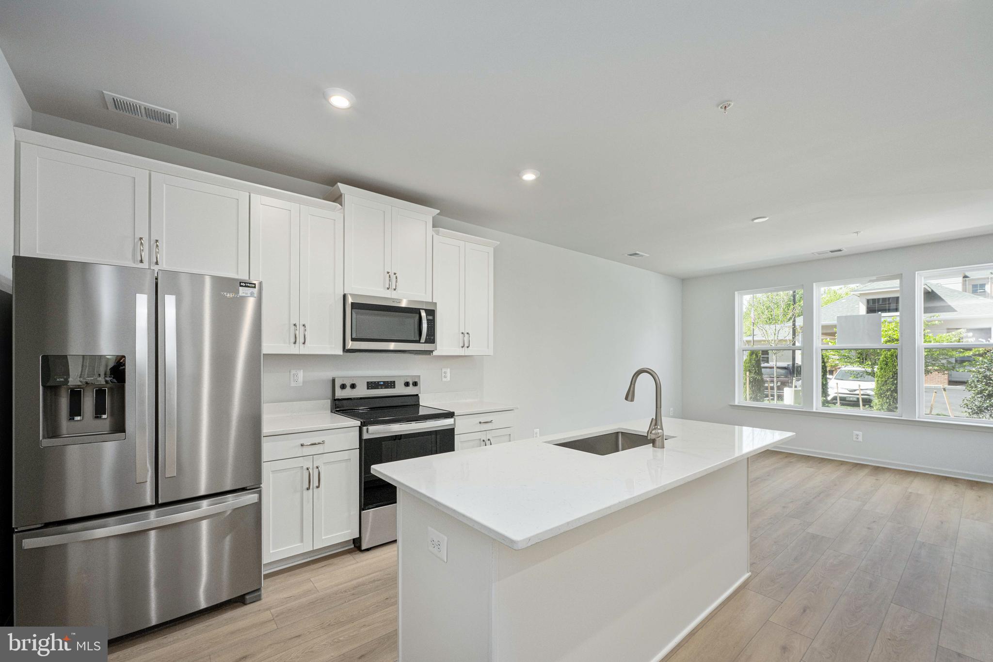 2540 Neabsco Common Place Woodbridge, VA 22191 - Photo 16 of 33 a kitchen with a refrigerator a sink and a stove top oven