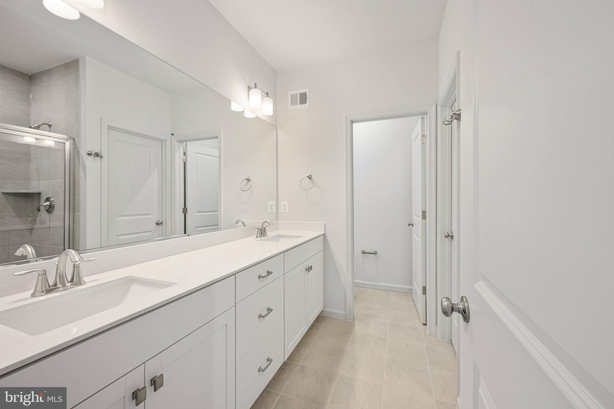 2540 Neabsco Common Place Woodbridge, VA 22191 - Photo 29 of 33 a spacious bathroom with a double vanity sink mirror double and shower
