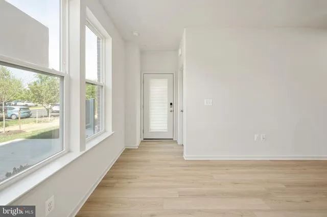 a view of a room with wooden floor and windows