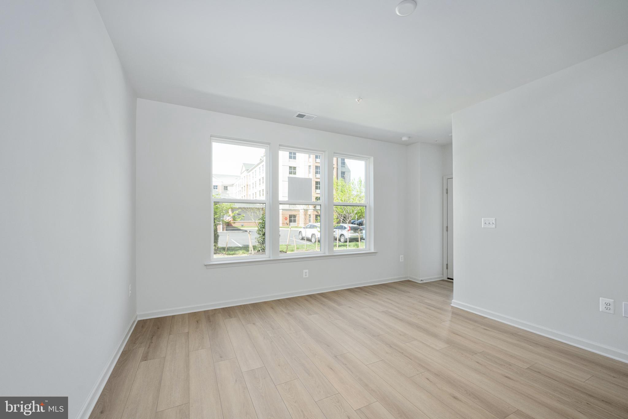 2540 Neabsco Common Place Woodbridge, VA 22191 - Photo 4 of 33 an empty room with wooden floor and windows