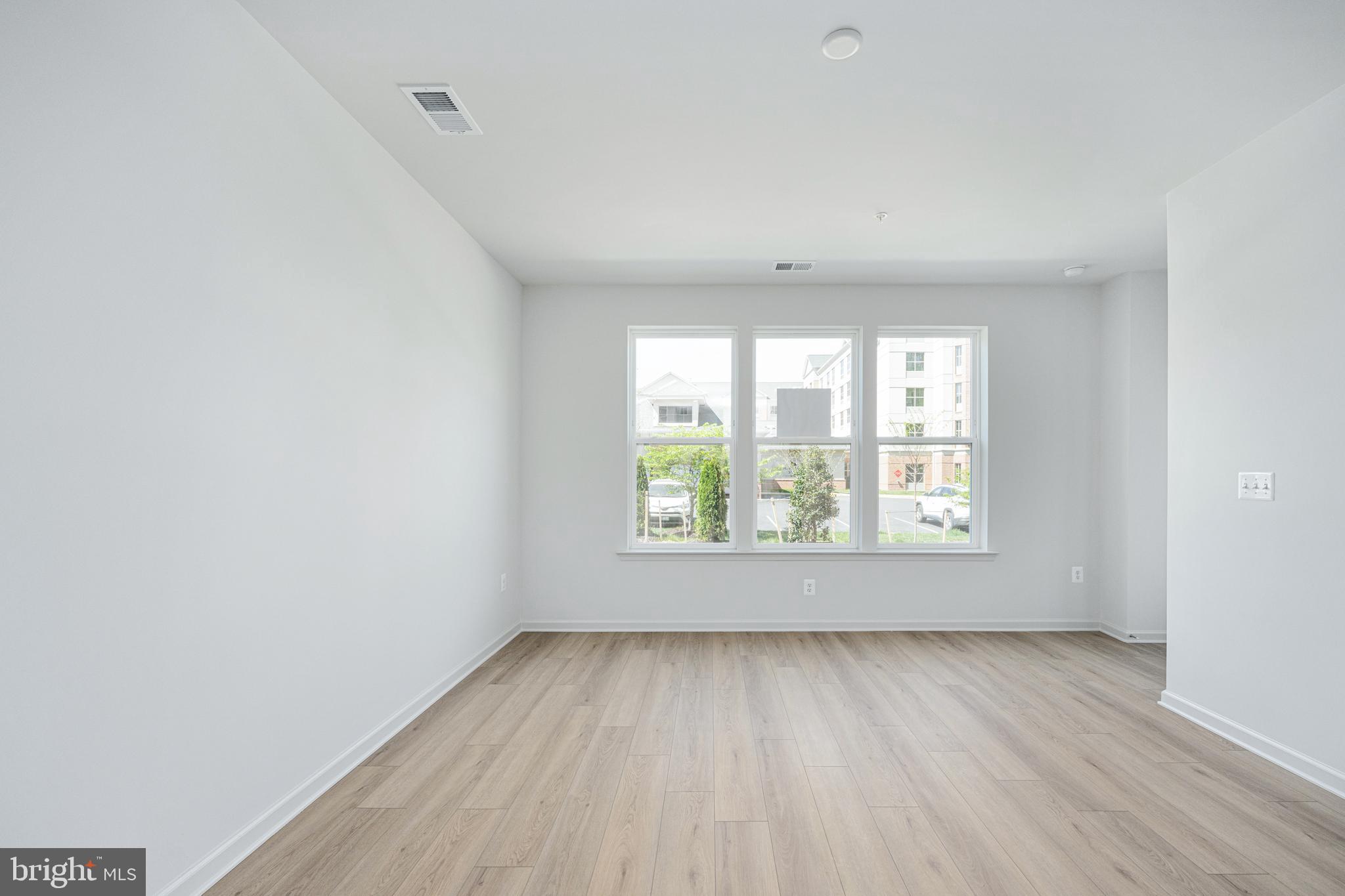2540 Neabsco Common Place Woodbridge, VA 22191 - Photo 5 of 33 an empty room with wooden floor and windows