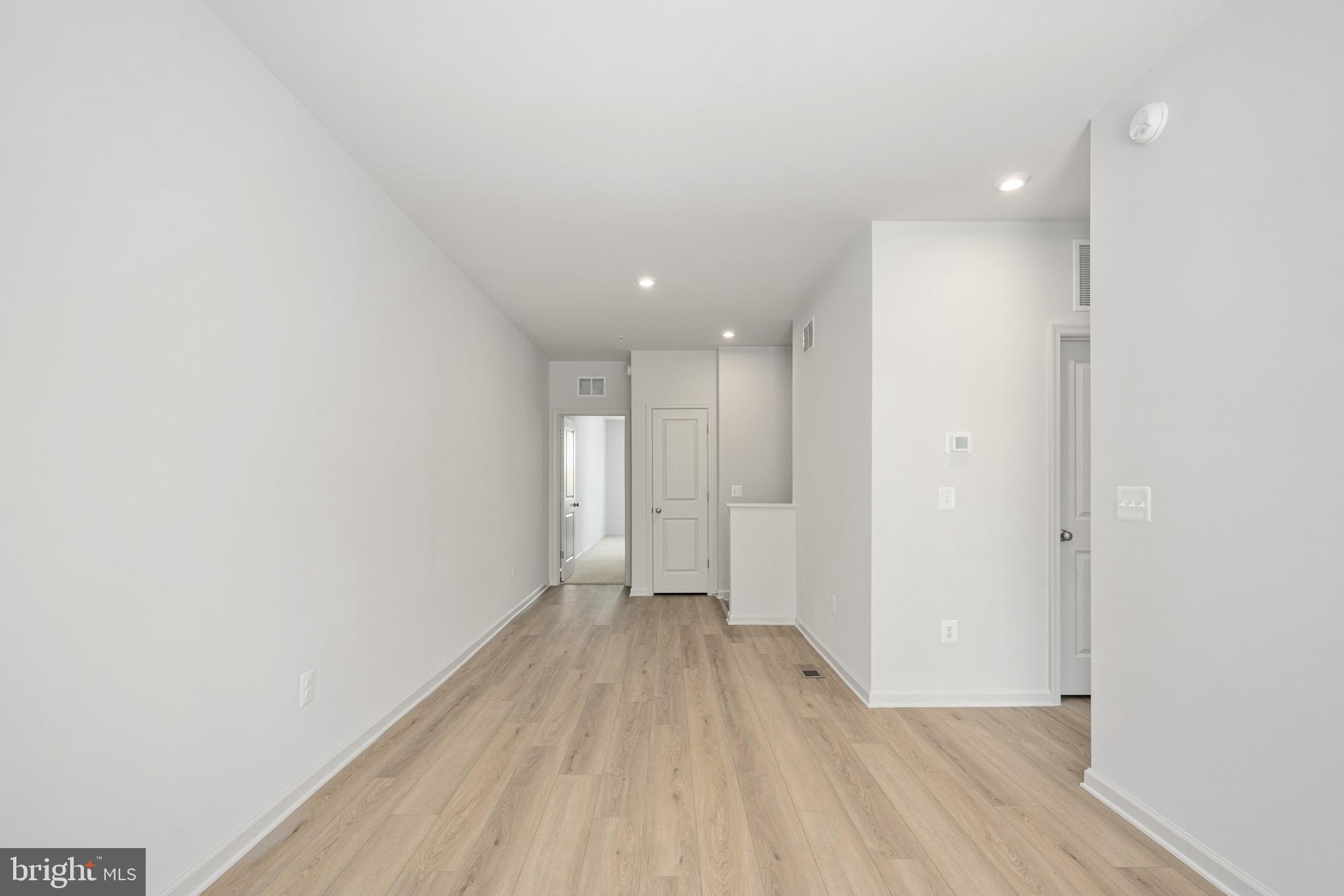 2540 Neabsco Common Place Woodbridge, VA 22191 - Photo 8 of 33 a view of a big room with wooden floor and windows