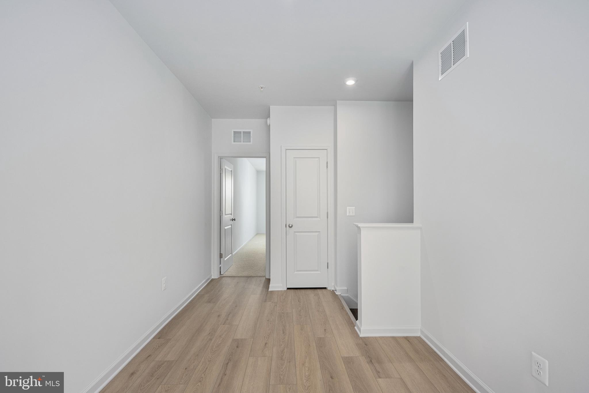 2540 Neabsco Common Place Woodbridge, VA 22191 - Photo 9 of 33 a view of a hallway with wooden floor