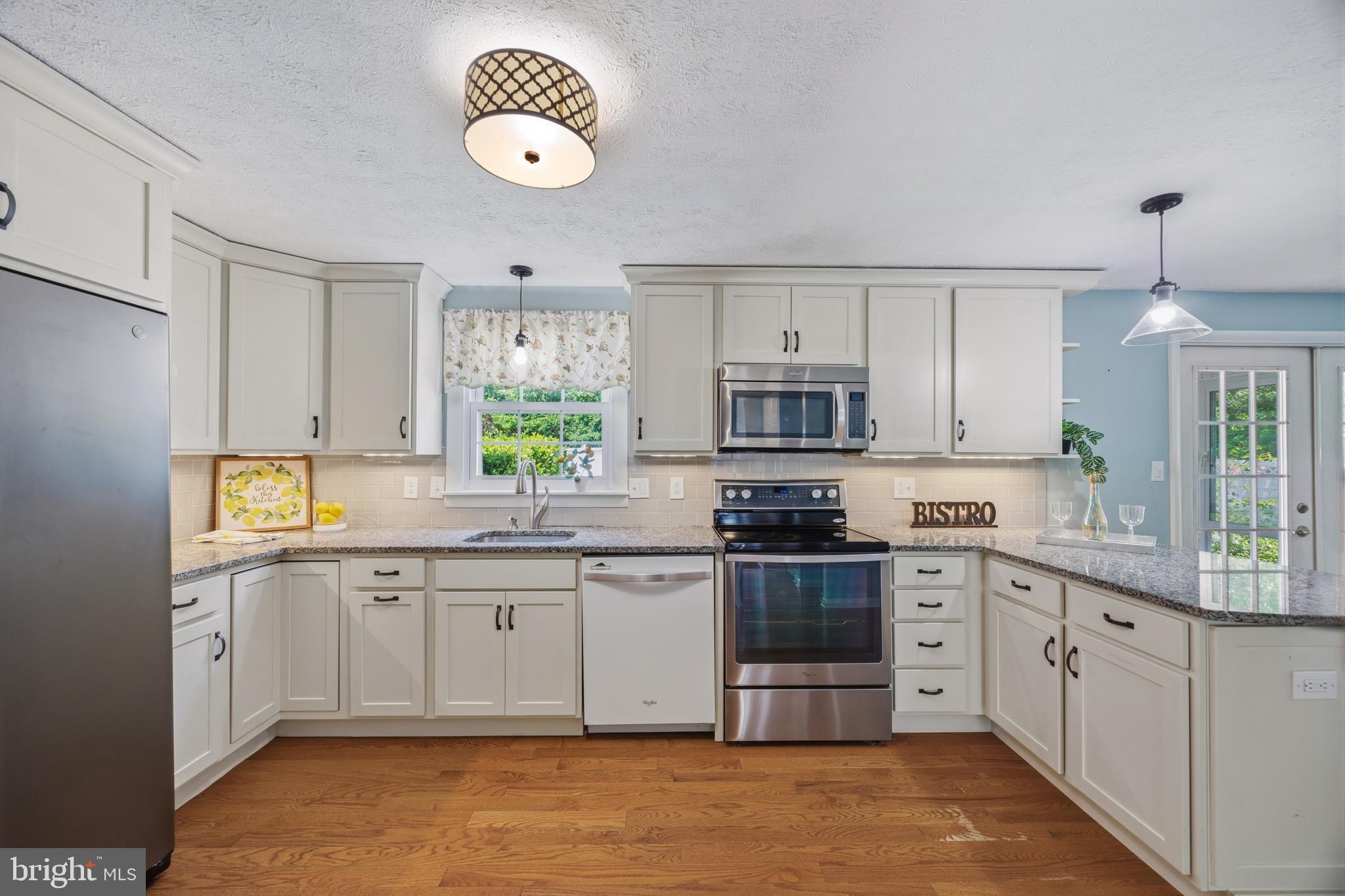 1506 Gollum Road Hanover, MD 21076 - Photo 13 of 44 a kitchen with stainless steel appliances granite countertop a stove sink and cabinets