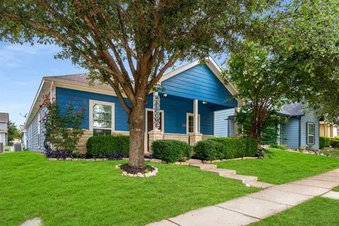 a front view of a house with a yard and plants