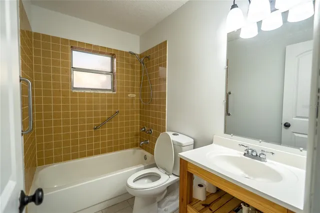 a bathroom with a sink mirror toilet and bathtub