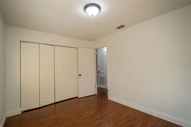 a view of an empty room and wooden floor