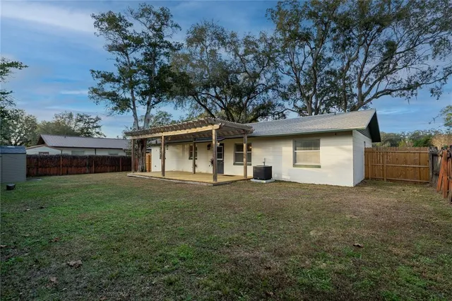 a front view of a house with a garden and tree