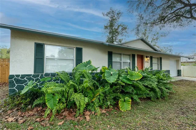 a flower garden in front of a house