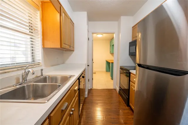 a kitchen with a sink and a refrigerator