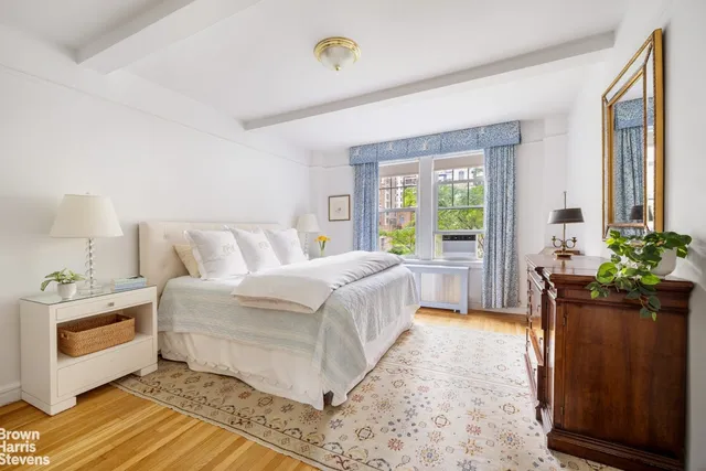 a spacious bedroom with a bed and a window