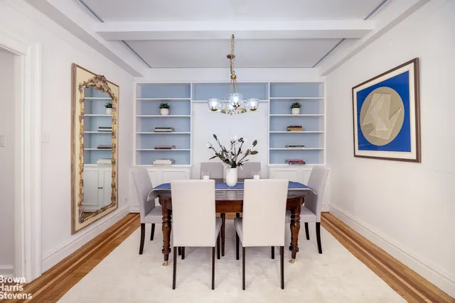 a view of a dining room with furniture a chandelier and wooden floor