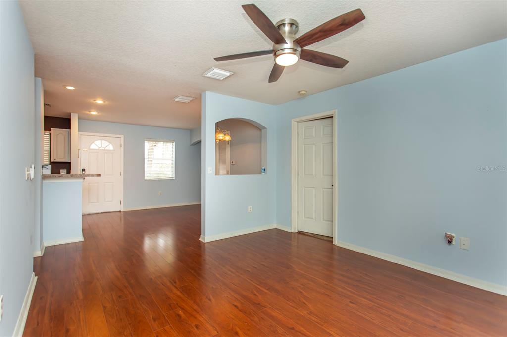 6740 Moonglow Drive, Unit 101 Port Richey, FL 34668 - Photo 20 of 39 an empty room with wooden floor and windows