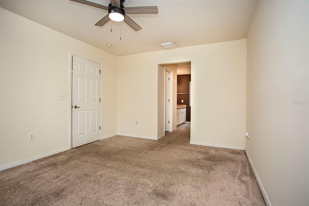 6740 Moonglow Drive, Unit 101 Port Richey, FL 34668 - Photo 26 of 39 an empty room with chandelier fan
